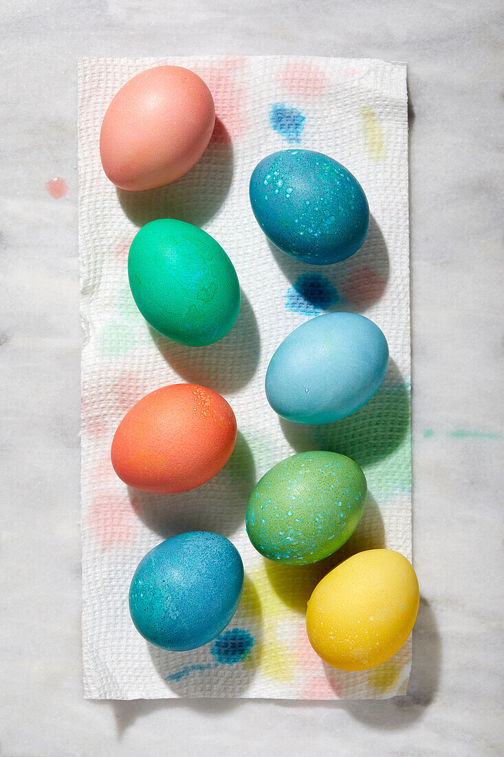 Overhead view of freshly colored Easter eggs on paper towel