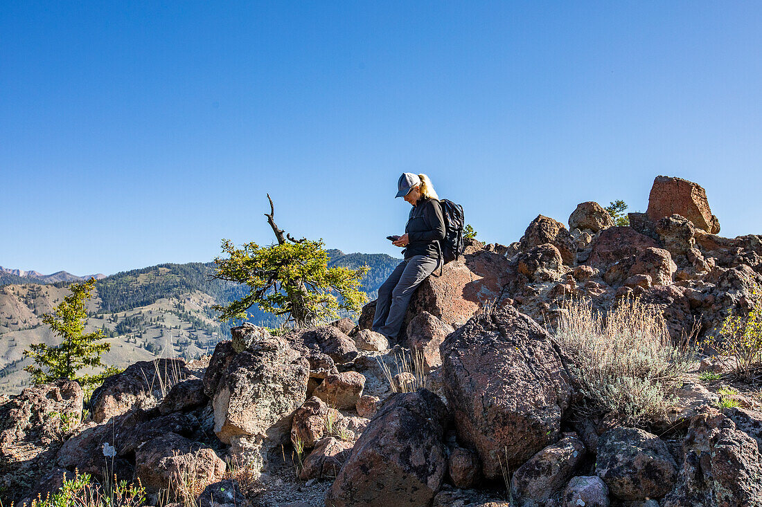 USA, Idaho, Sun Valley, Senior woman taking break while on hike