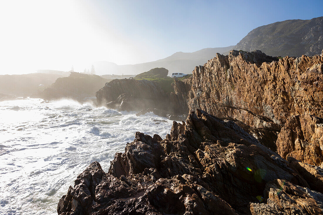 South Africa, Hermanus, Waves crashing against rocks on Kammabaai Beach