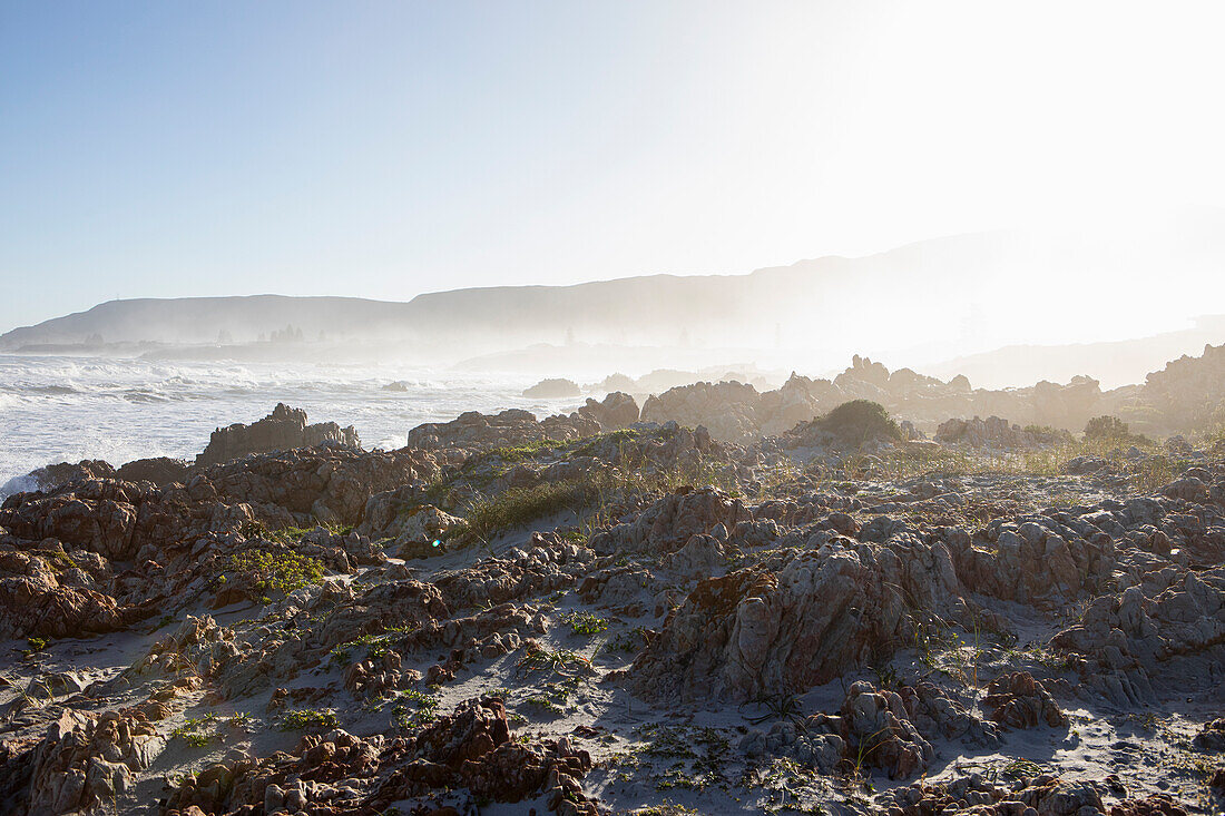 South Africa, Hermanus, Waves crashing against rocks on Kammabaai Beach