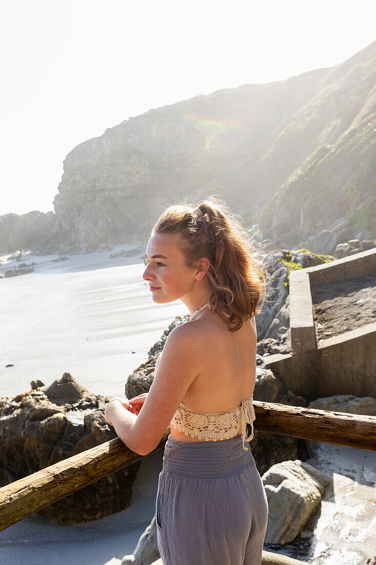 South Africa, Hermanus, Teenage girl (16-17) looking at sea in Walker Bay Nature Reserve