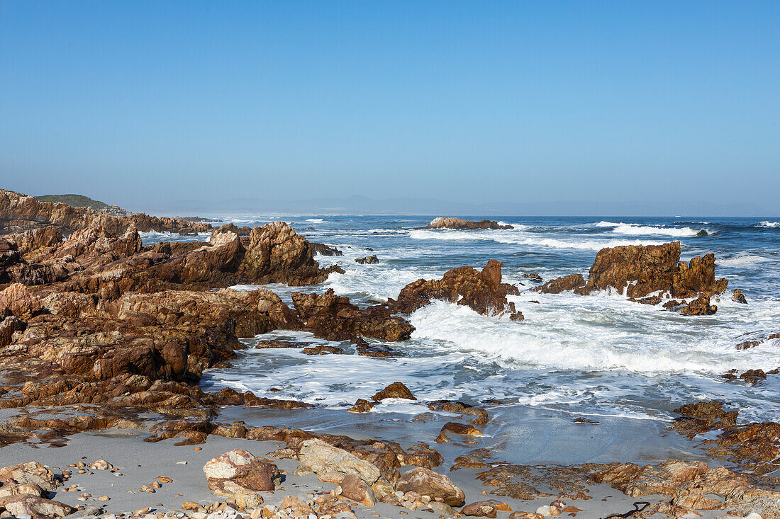 South Africa, Hermanus, Rocky coastline and sea at Kammabaai Beach