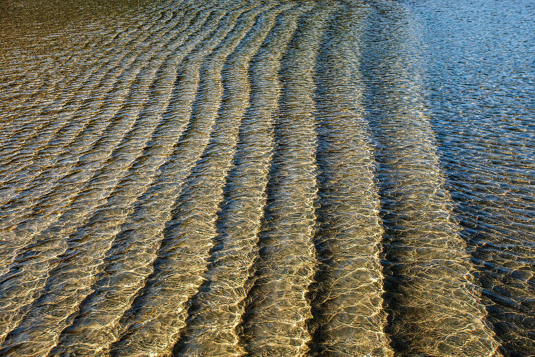 Underwater ridges in sand beneath incoming tide 