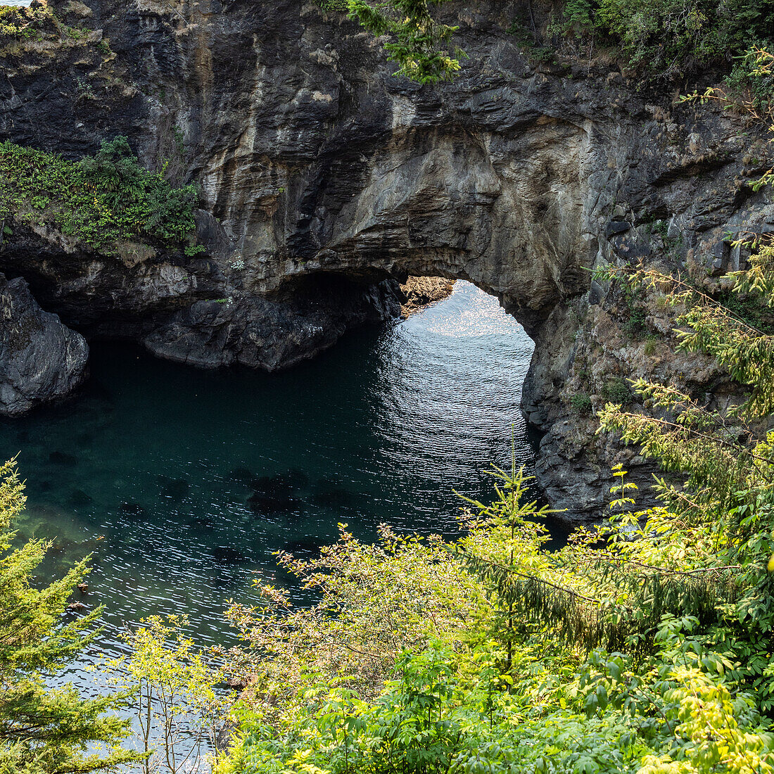 Natural arch formation above rippled sea 