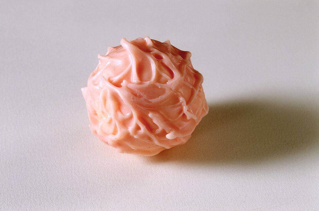 A pink chocolate truffle