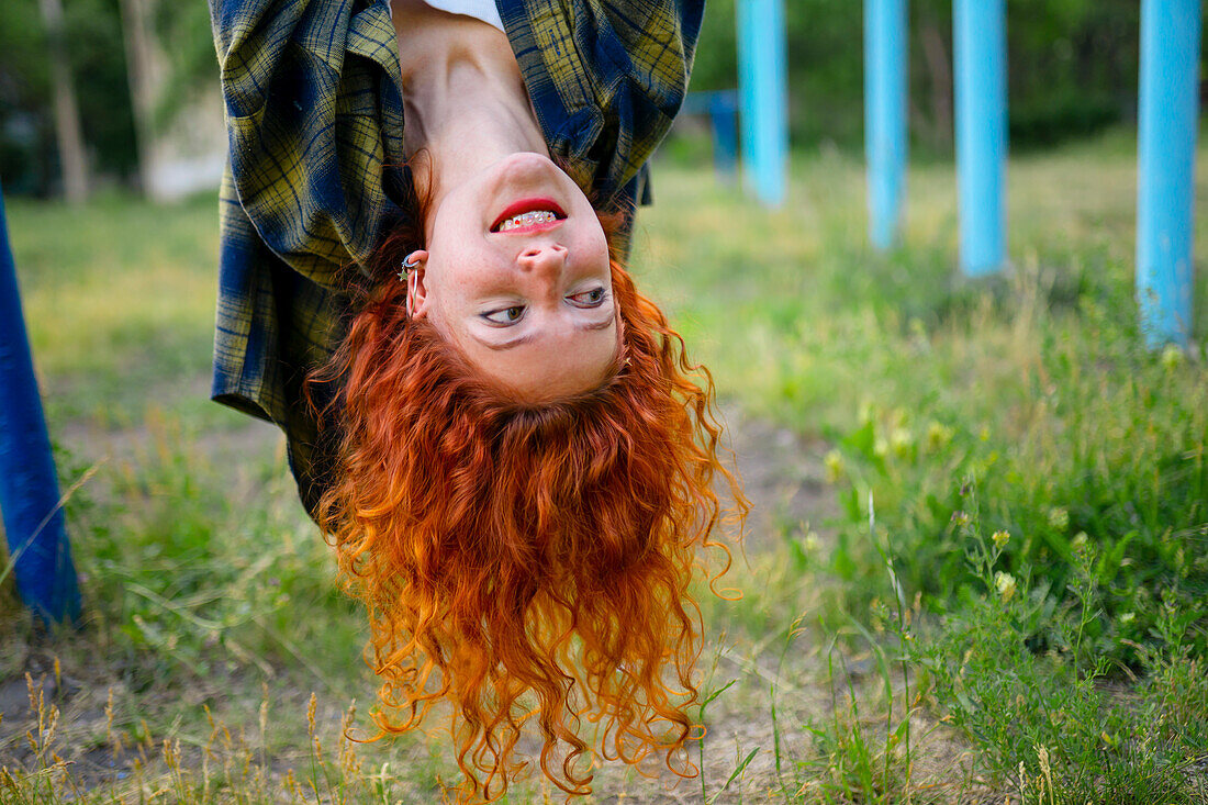 Upside down portrait of redhead woman looking away