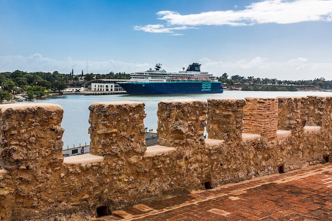 A cruise ship from the Pullmantur cruise liine docked at the Sans Souci Terminal in the Port of Santo Domingo. Viewed from the walls of the historic Ozama Fortress in the Colonial City of Santo Domingo, Dominican Republic. A UNESCO World Heritage Site.