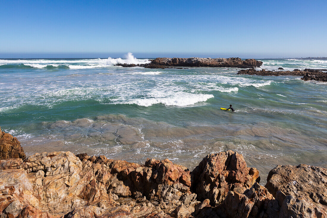 South Africa, Hermanus, Boy (10-11) surfboarding at Kammabaai Beach