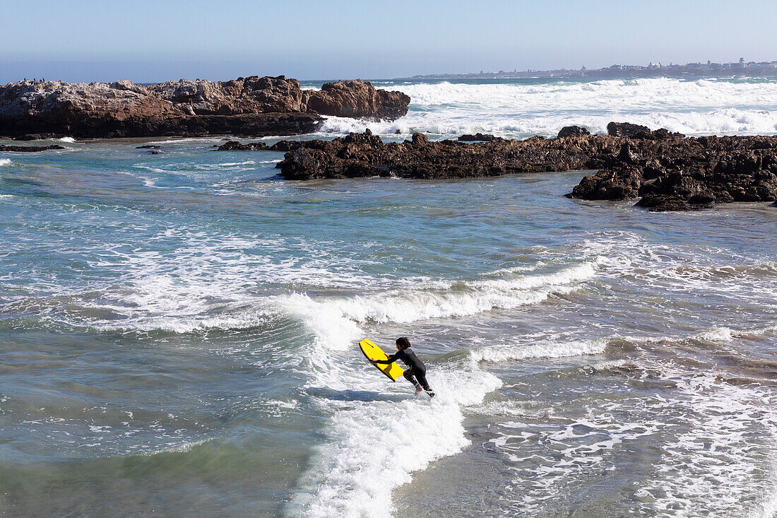 South Africa, Hermanus, Boy (10-11) surfboarding at Kammabaai Beach