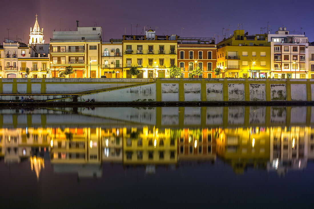 Twilight Reflections on Calle Betis, Seville