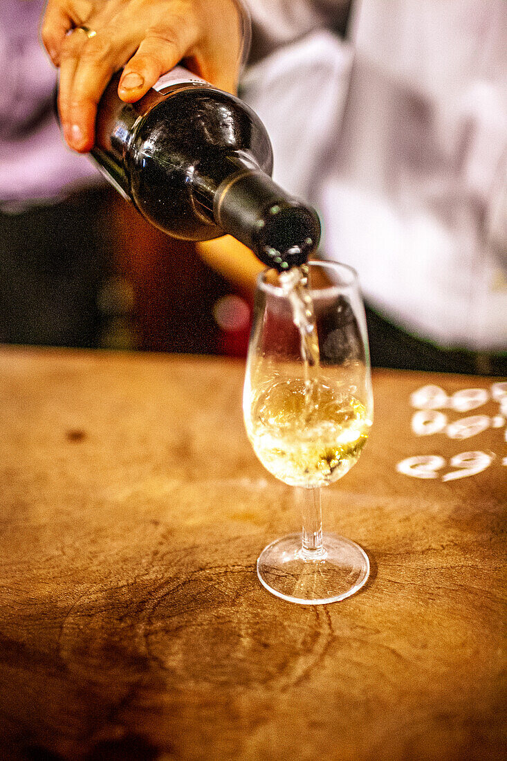 Waiter Pouring Fino Sherry at Traditional Seville Tavern
