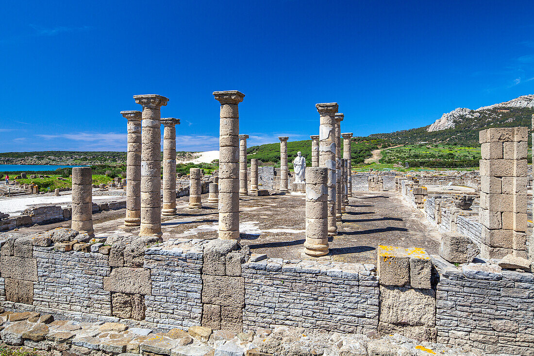 Ancient Roman Basilica Ruins at Baelo Claudia Under Clear Blue Sky