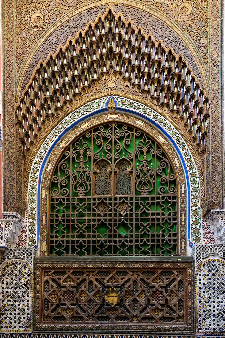 Fes, Morocco. Stunning exterior of a mosque wall with hand carved plaster, metal and wood work.