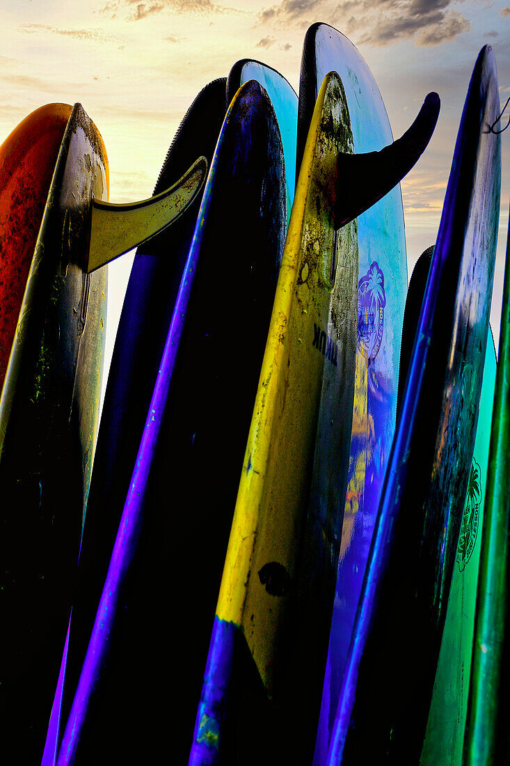 Stacked surf boards at sunset after a day of surf school in Canggu, Bali, Indonesia