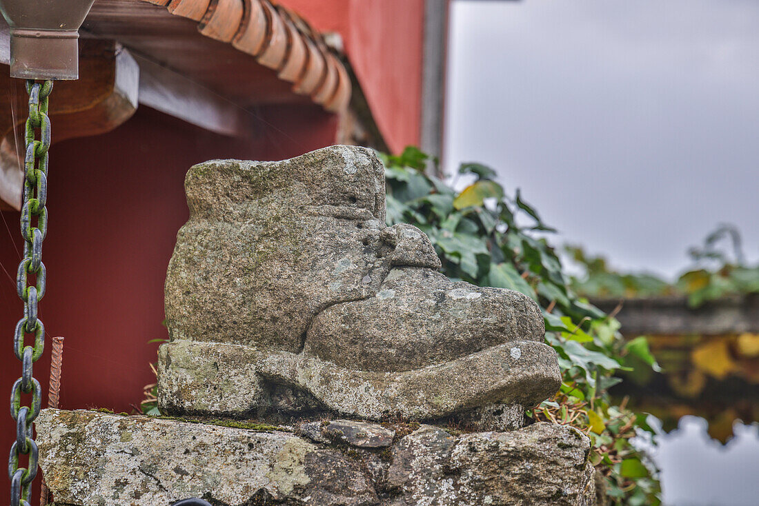 Spain, Galicia. Shoes along the Camino de Santiago (Way of St. James) between Lavacolla and Santiago de Compostela