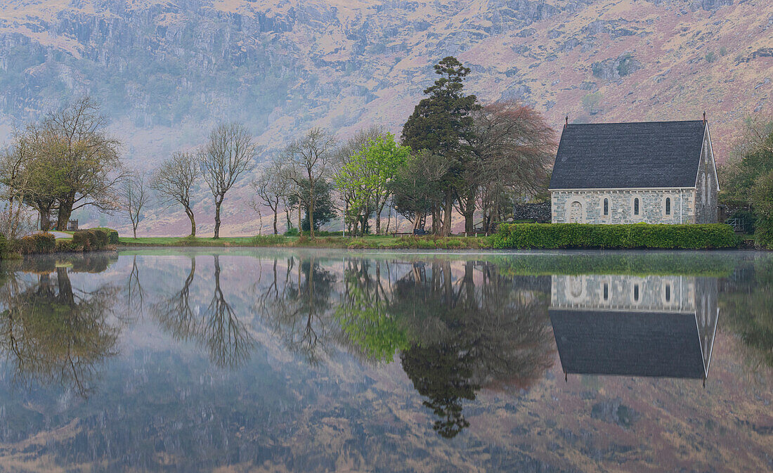 Ireland, Cork, Gougane Barra. Church and mountain reflections in lake.