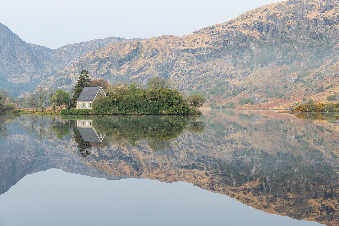 Ireland, Cork, Gougane Barra. Church and mountain reflections in lake.