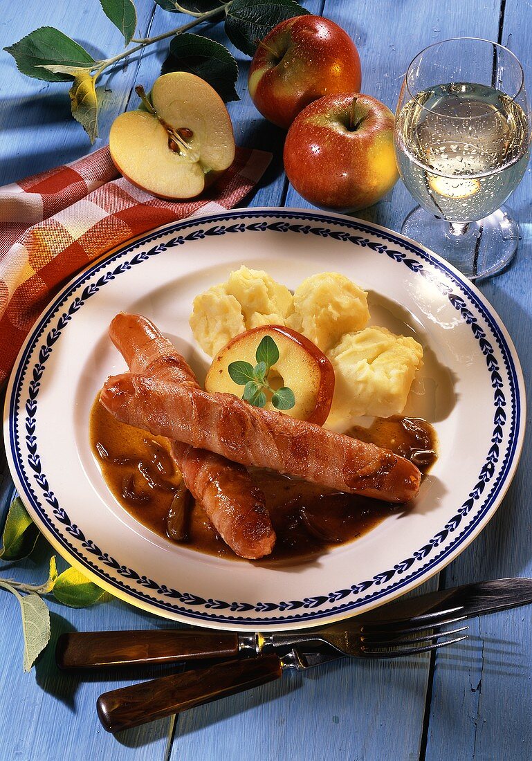 Sausage wrapped in bacon with apple slice & mashed potato