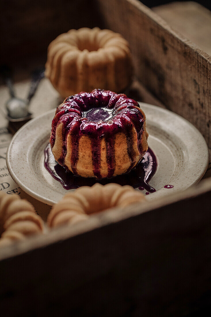 Small lemon bundt cakes with blueberry icing