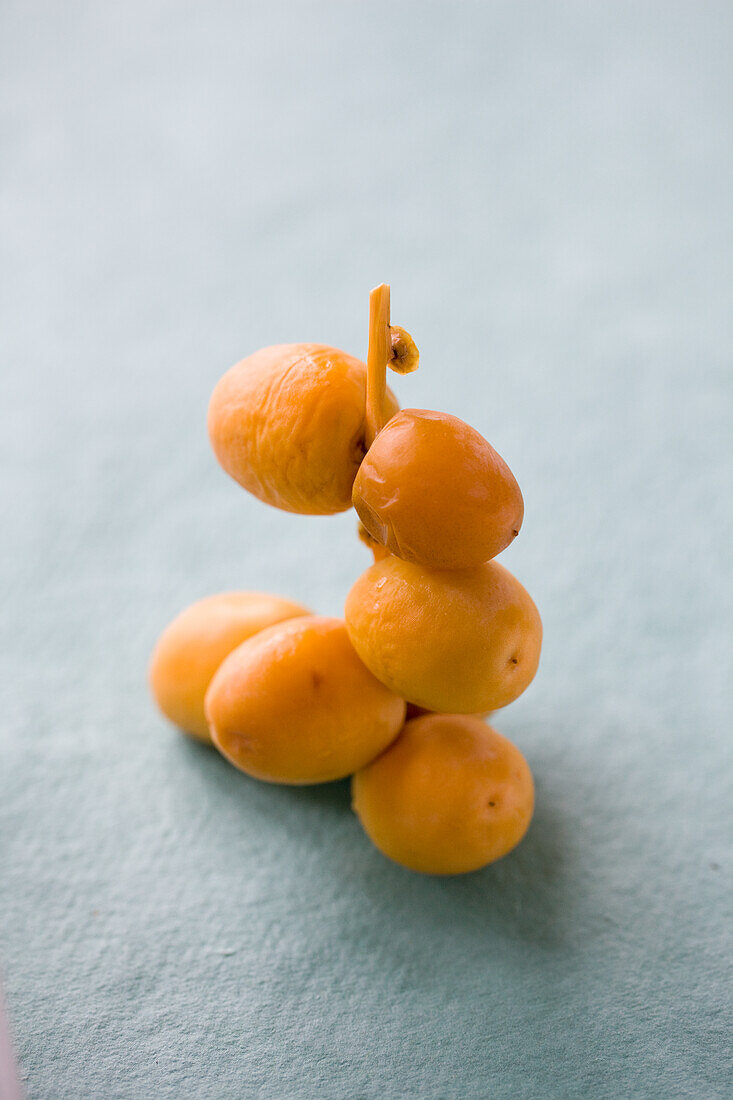 Yellow, fresh dates on a stick