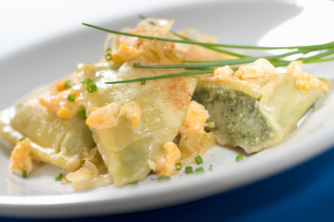 Vegetarian ravioli with fried onions and chives