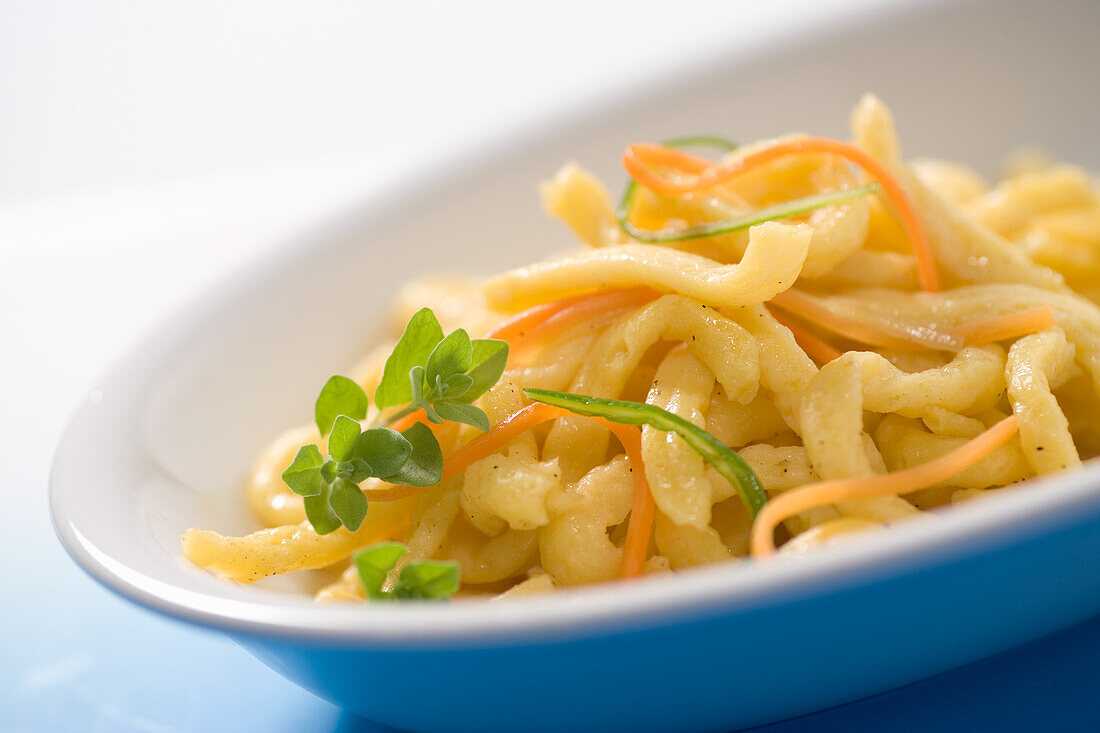 Butter spaetzle with carrot strips