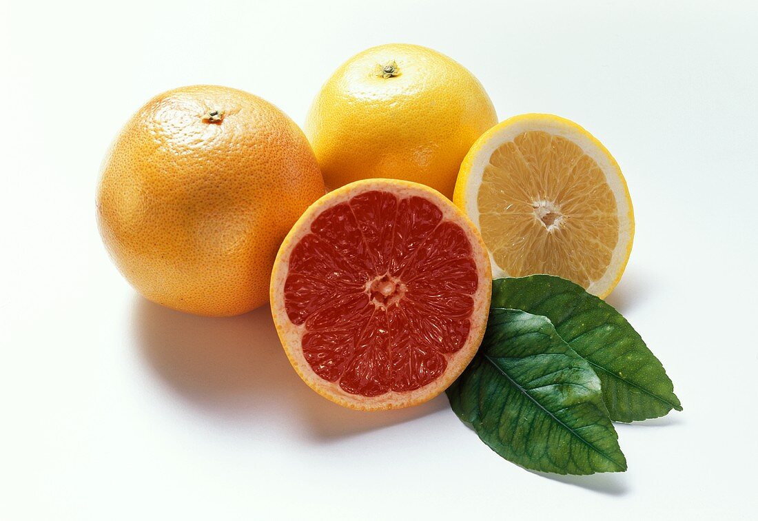 Pink and yellow grapefruit, whole and half of each