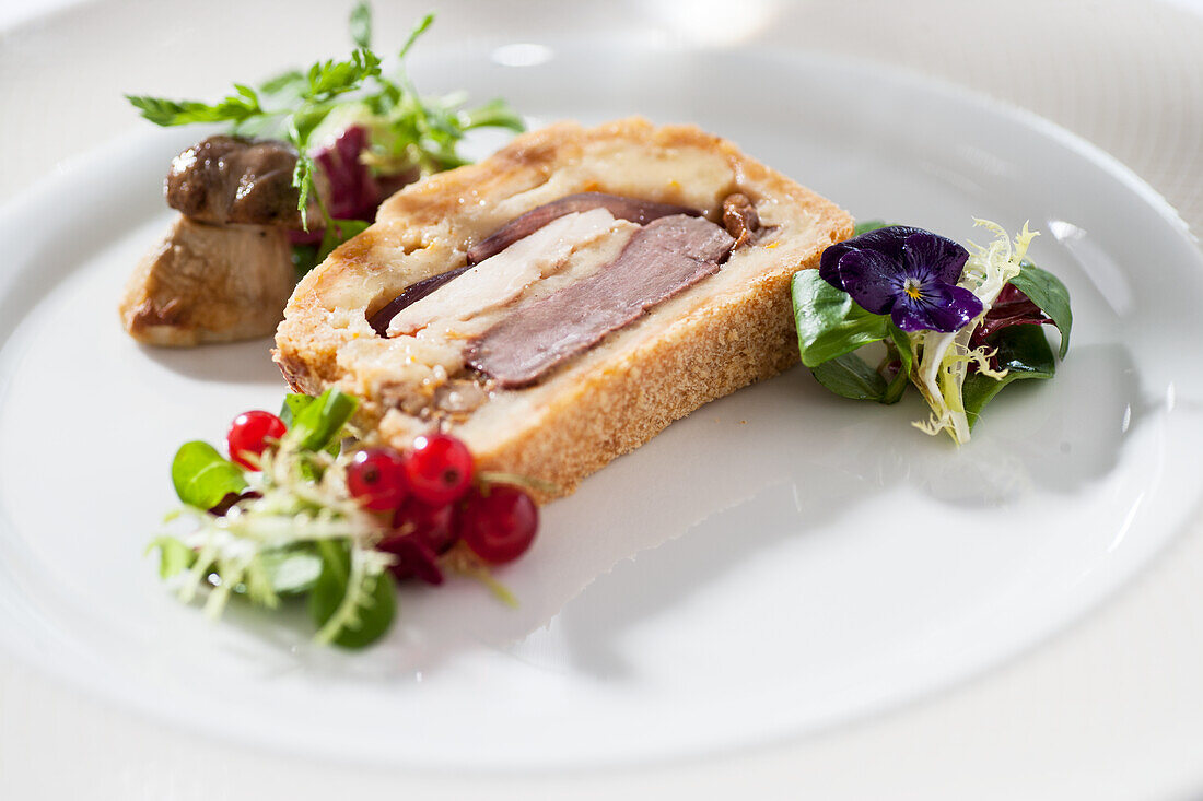 Leipzig meat pie with leaf salad and redcurrants