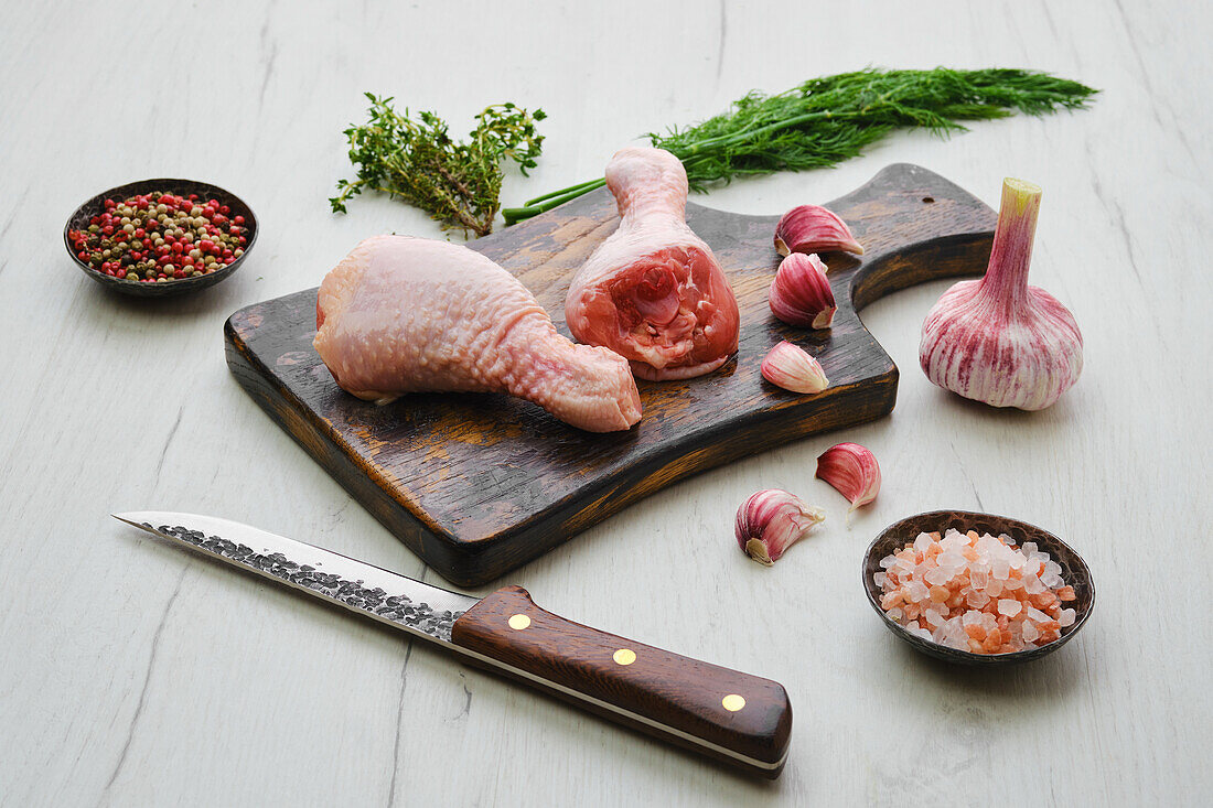 Raw chicken drumsticks with garlic and spices