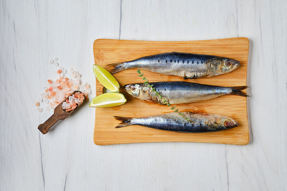 Raw smelts on a wooden board