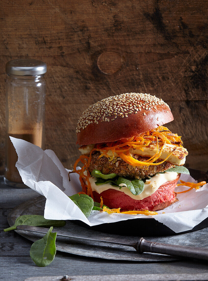 Vegetarian lentil burger with halloumi and carrots