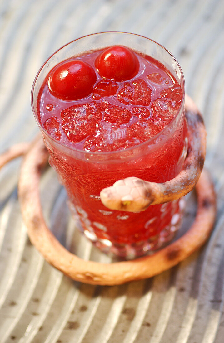 Bloody Mary with cocktail cherries and ice cubes