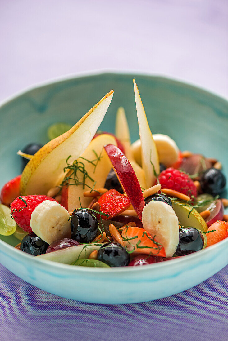 Fruit salad with berries, bananas and pears