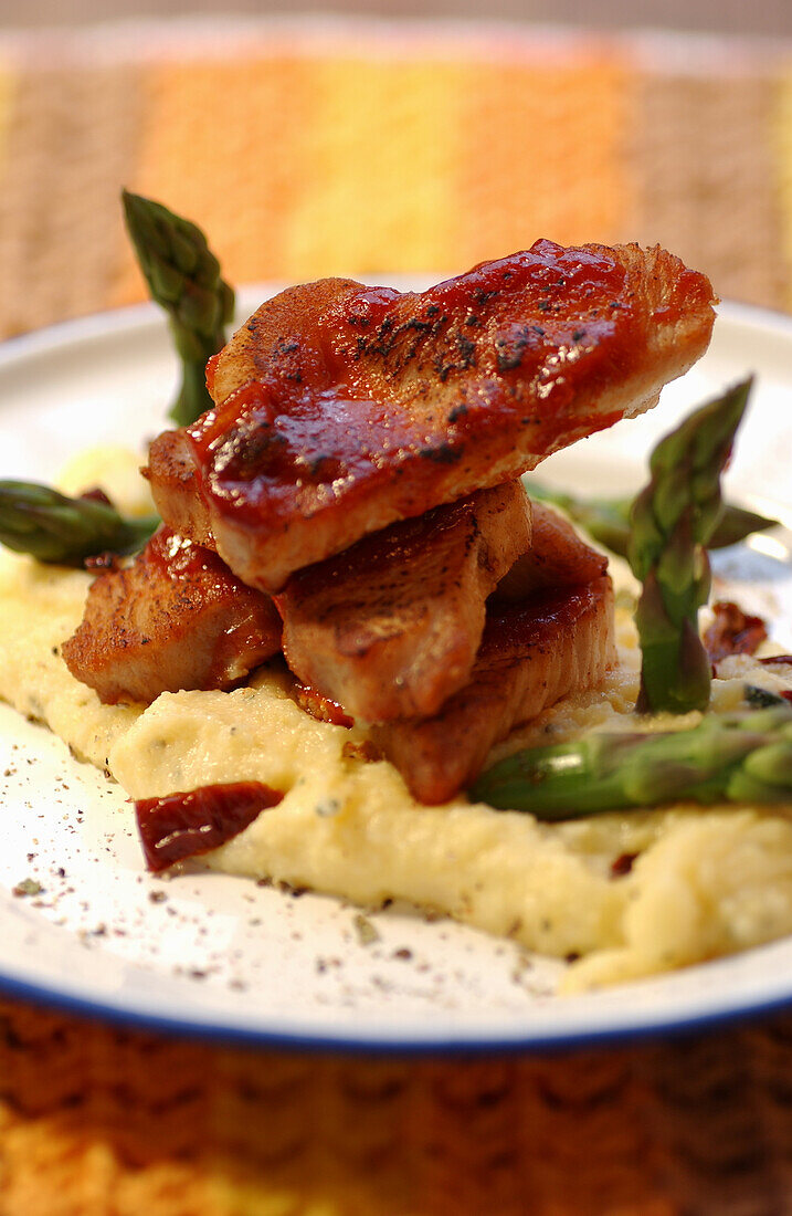 Turkey steaks on polenta with asparagus