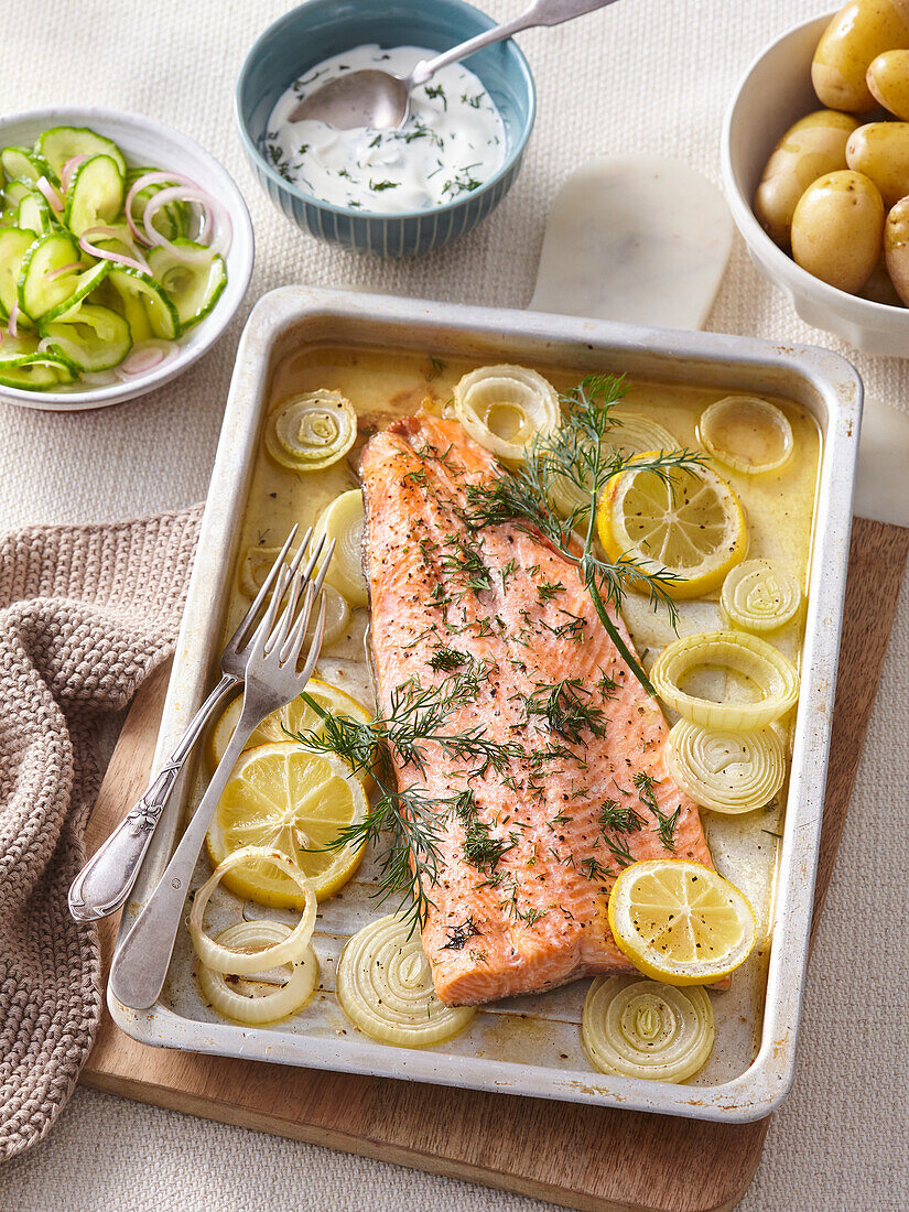 Trout on a tray with lemons and onions