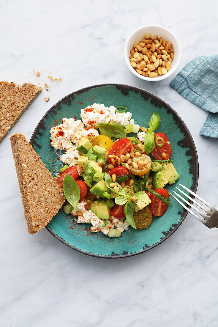 Tomato and avocado salad with cottage cheese and grain bread