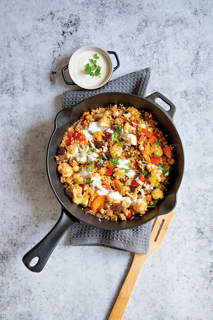 Couscous vegetable pan with yoghurt sauce