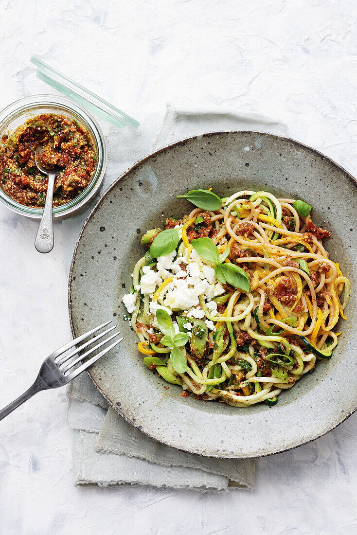 Courgette spaghetti with pesto and feta