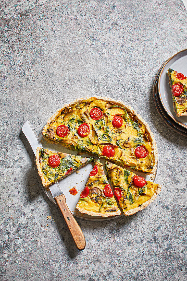 Vegan mushroom and spinach quiche with tomatoes