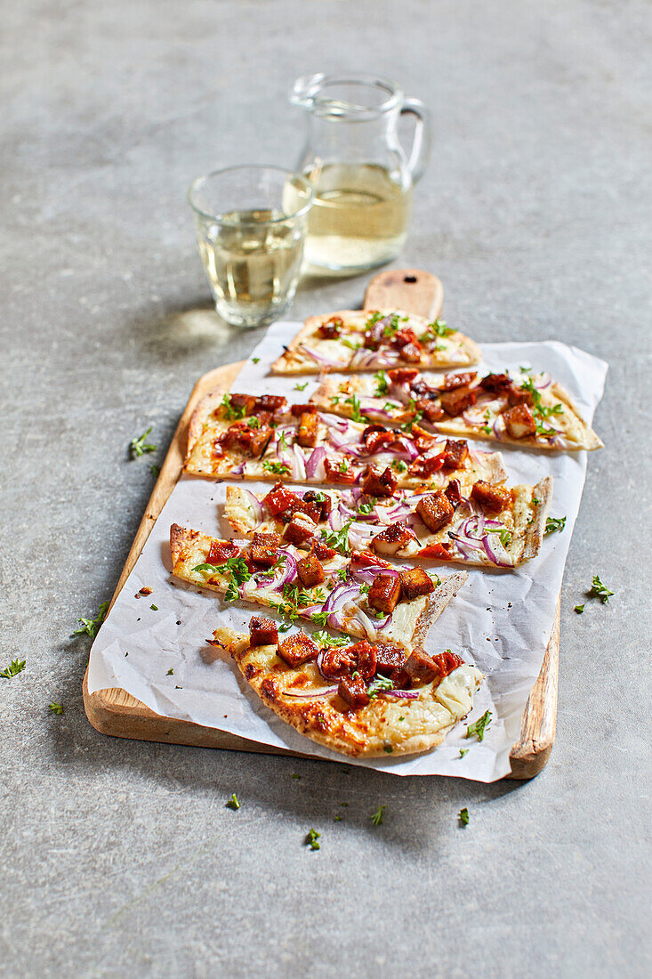 Vegan tarte flambée with smoked tofu and sun-dried tomatoes