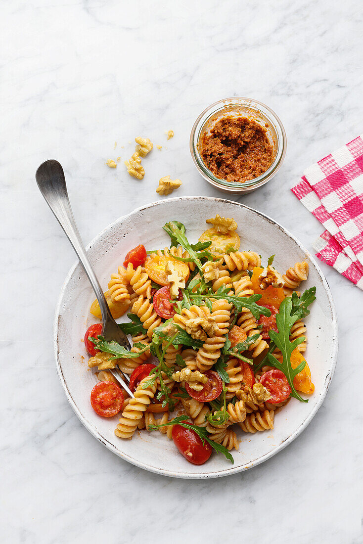 Pasta salad with tomatoes and walnut pesto