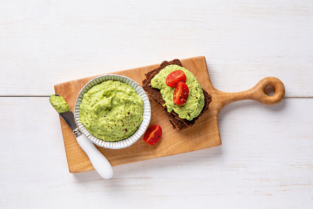 Pea spread on bread with cherry tomatoes