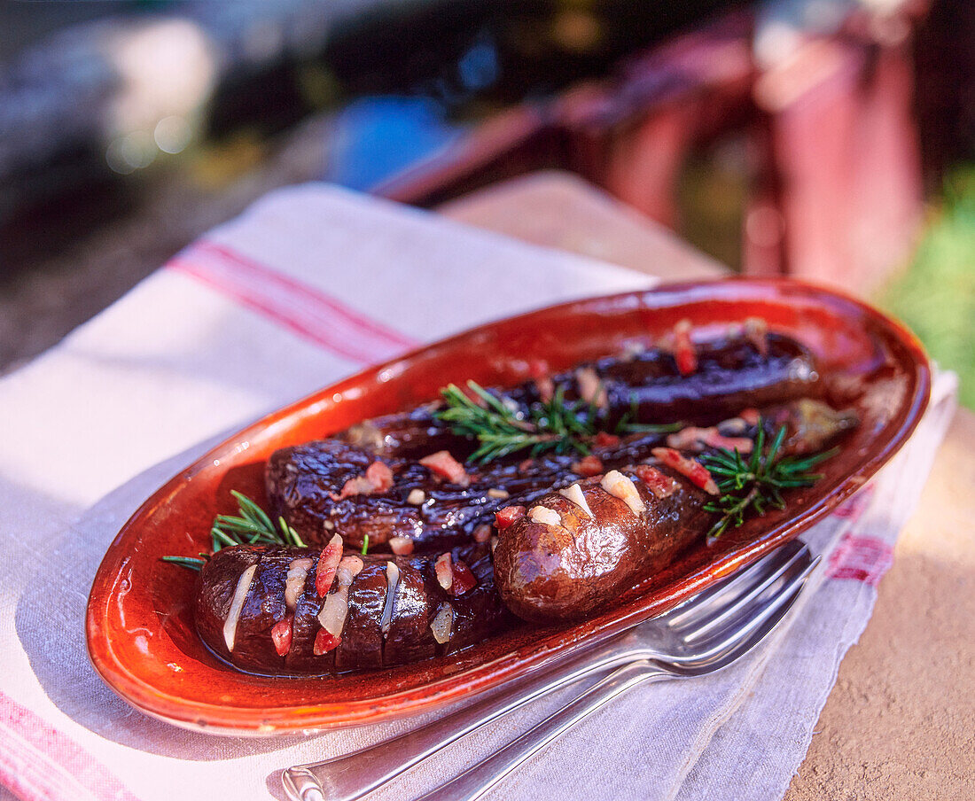 Oven-baked aubergines with bacon and rosemary