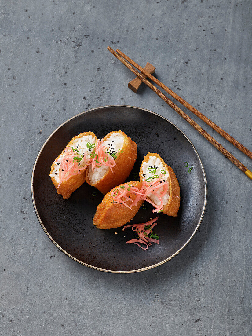 Inari sushi with pickled ginger and sesame seeds