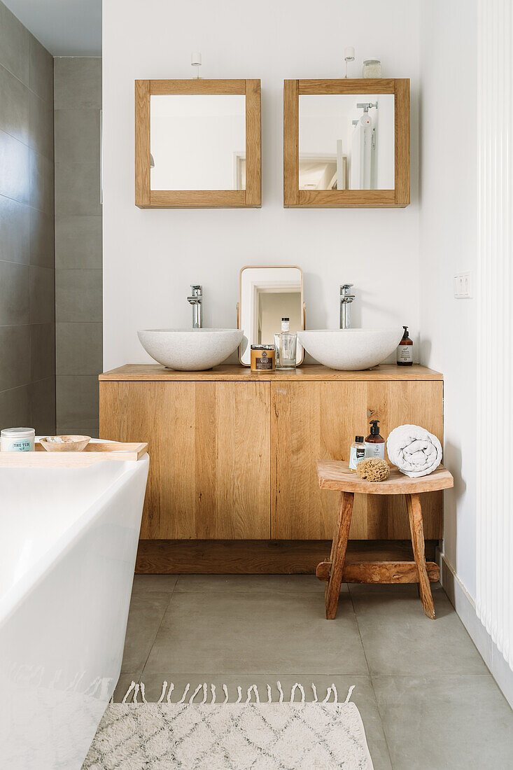 Modern bathroom with double washbasin, wooden accents and mirrors