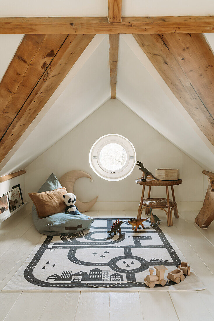 Children's room in the attic with toys and play rug