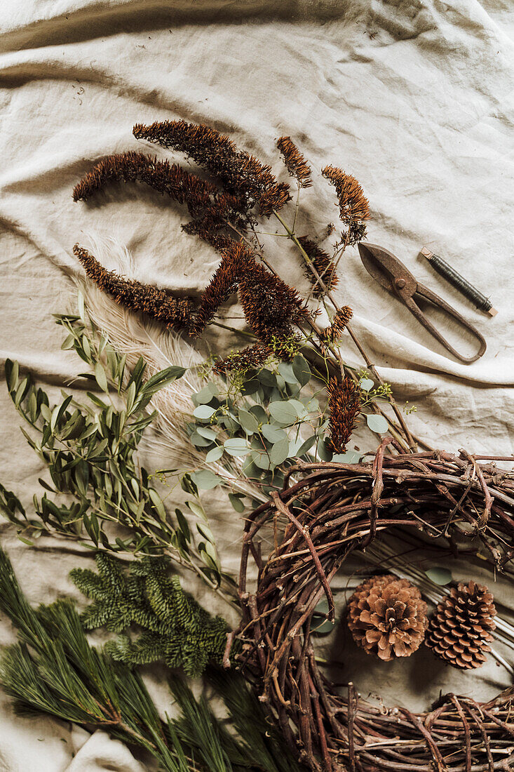 Materials for making a natural autumn wreath on linen cloth