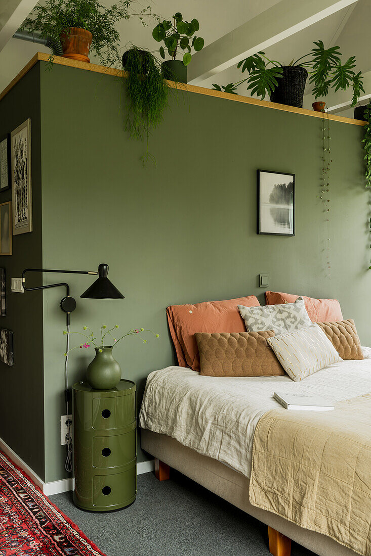 Bedroom with green wall, plants and carpet