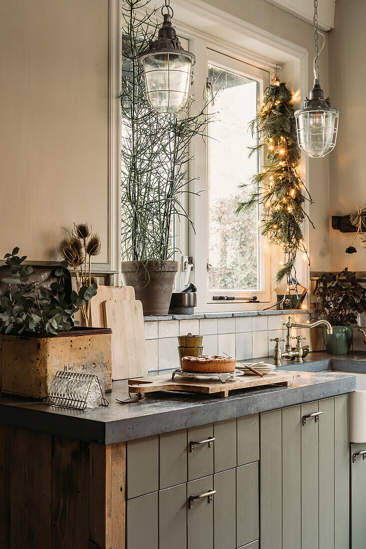 Kitchen with concrete worktop, wooden cabinets and Christmas decorations