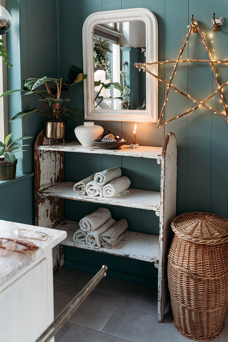 Shabby chic bathroom shelf with towels, mirror and illuminated star